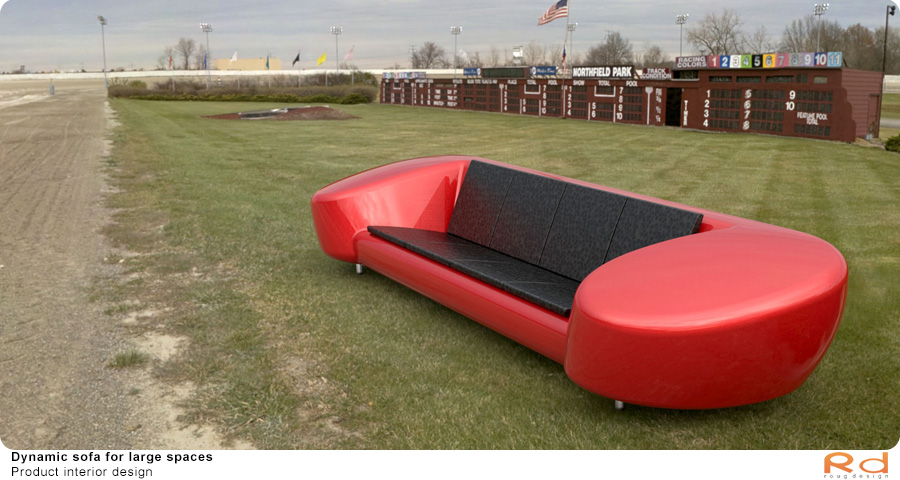 Red sofa placed on a grassy outdoor field, combining modern design with nature. 